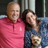 Bethany's president and CEO Keith Cureton sits on couch with wife and dog